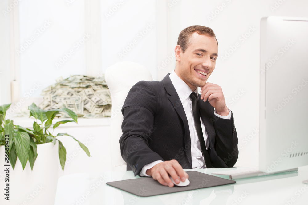Successful businessman. Happy young businessman sitting at his w Successful businessman. Happy young businessman sitting at his w