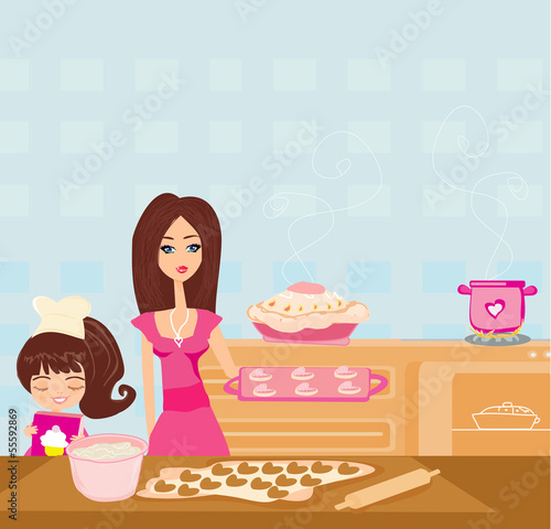Happy daughter helping her mother cooking in the kitchen