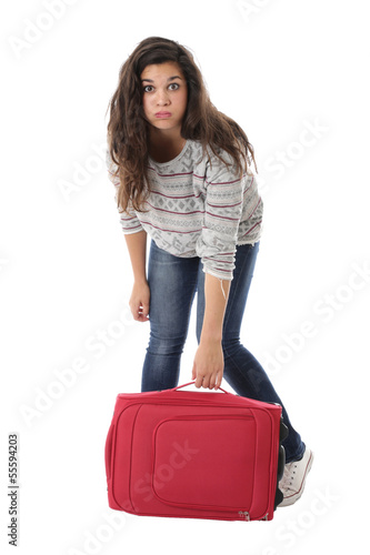 Model Released. Young Woman Lifting a Heavy Suitcase