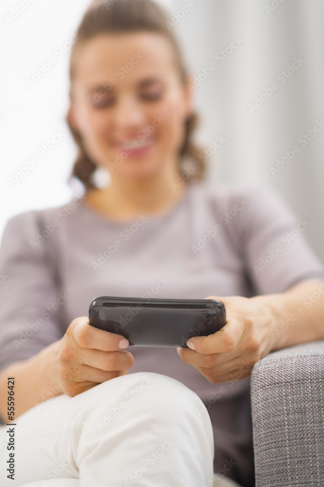 Closeup on cell phone in hand of happy young woman writing sms Closeup on cell phone in hand of happy young woman writing sms