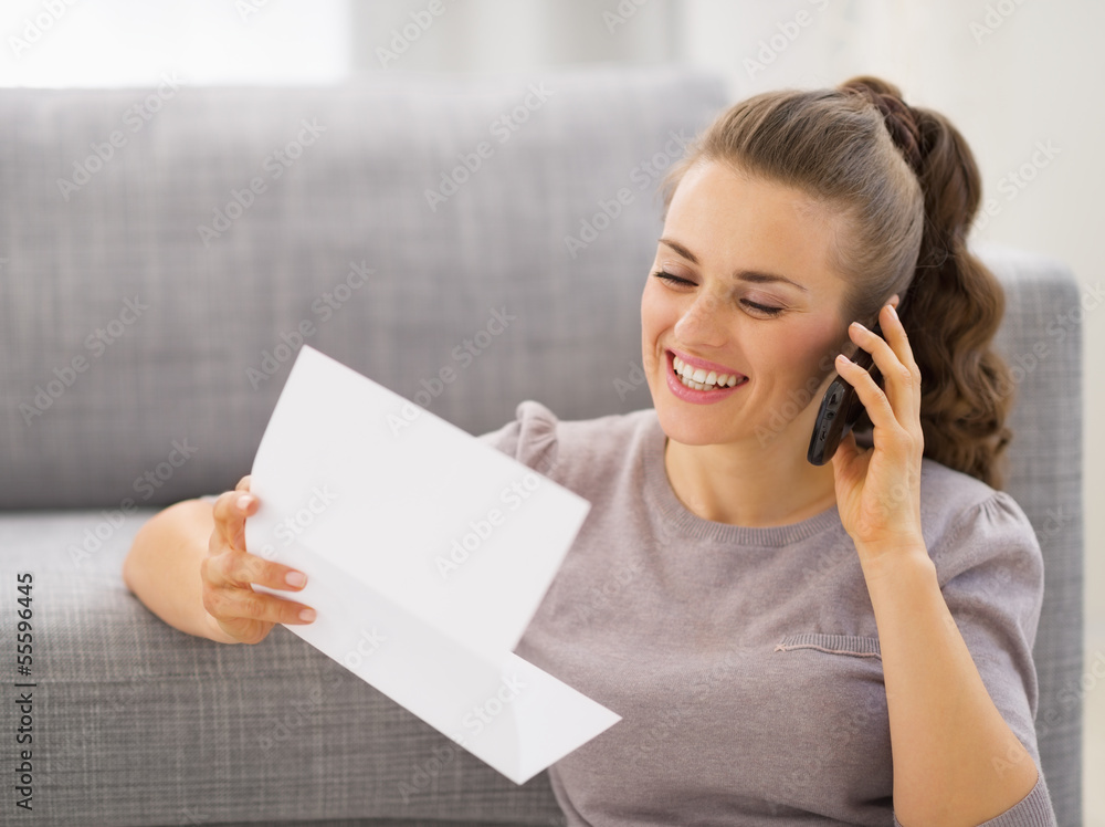 Happy young woman with letter talking cell phone Happy young woman with letter talking cell phone