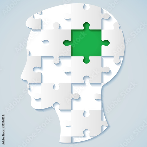 Image of a human face in the form of a jigsaw puzzle with a gree