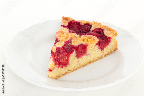 Eating delicious slice of raspberry cake