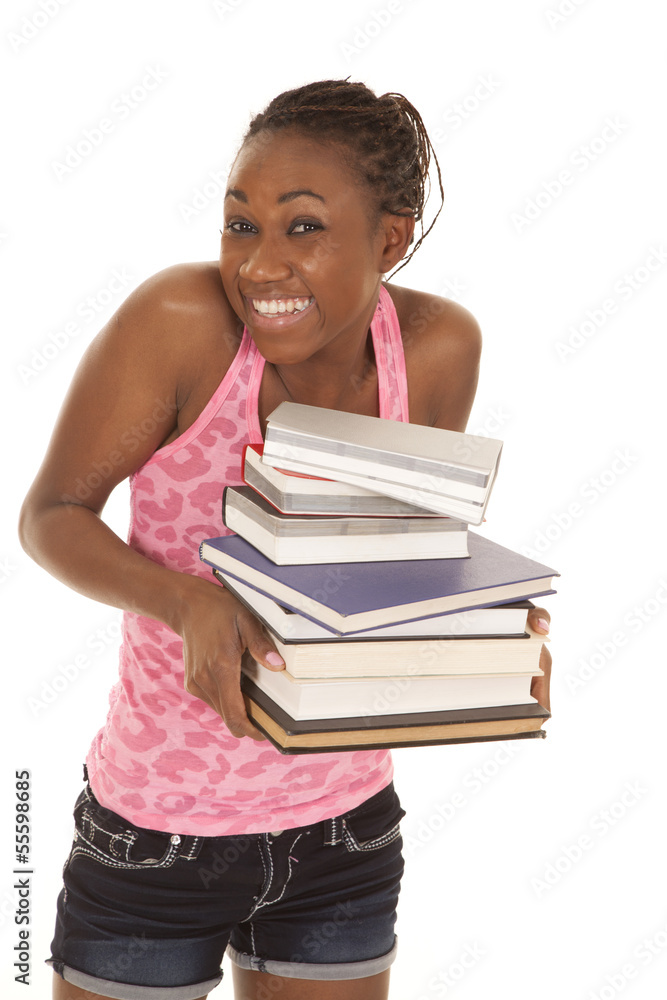 woman pink tank smile hold stack of books woman pink tank smile hold stack of books