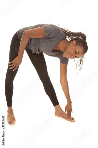 woman in gray shirt fitness stretch bend down