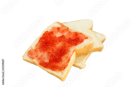 Strawberry jam spread on bread on isolated white background