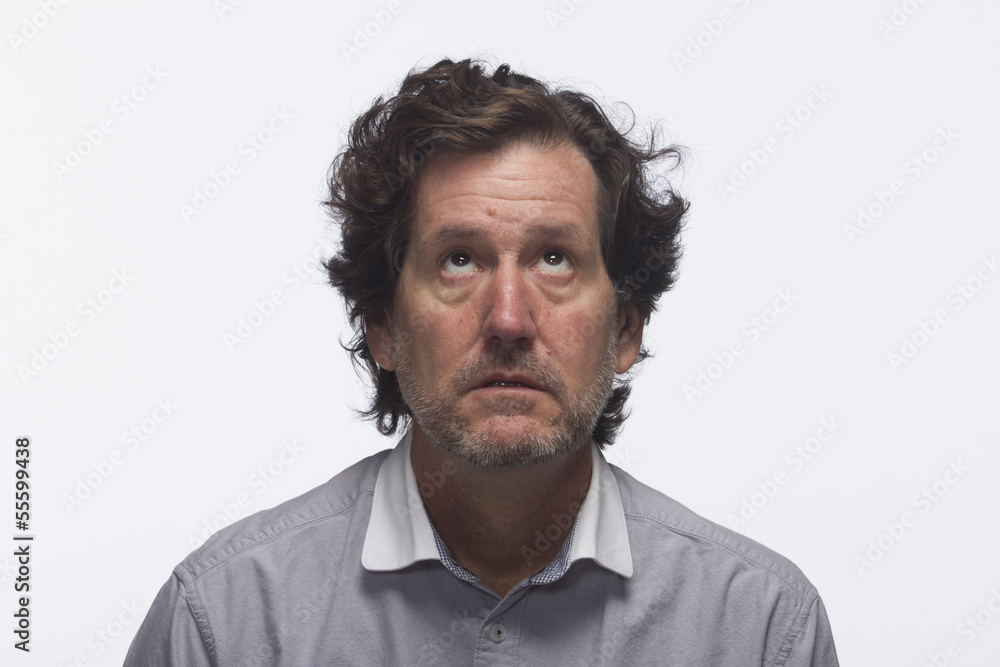 Man looks annoyed as he looks up, horizontal Man looks annoyed as he looks up, horizontal
