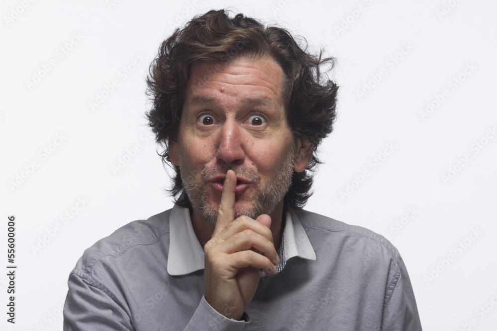 Man making hush gesture, horizontal Man making hush gesture, horizontal