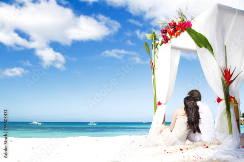 wedding arch decarated with flowers on beach photo