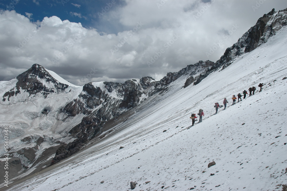 Climbers climbing Aconcagua peak in winter conditions
