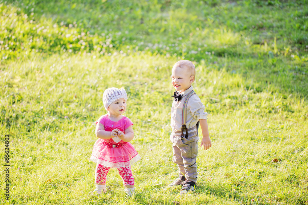 Fototapeta premium Children in beautiful spring green field