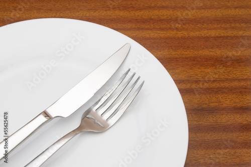 White place setting on wooden table