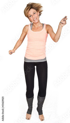 Cute woman standing and dancing on isolated white background