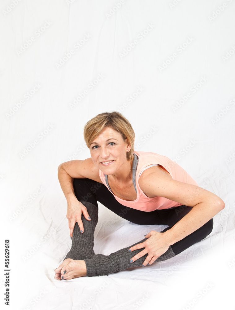 Cute woman sitting and stretching on isolated white background Cute woman sitting and stretching on isolated white background