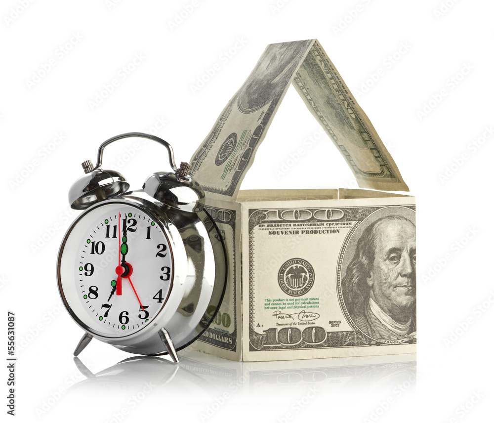 house made of dollars and alarm clock. house made of dollars and alarm clock.