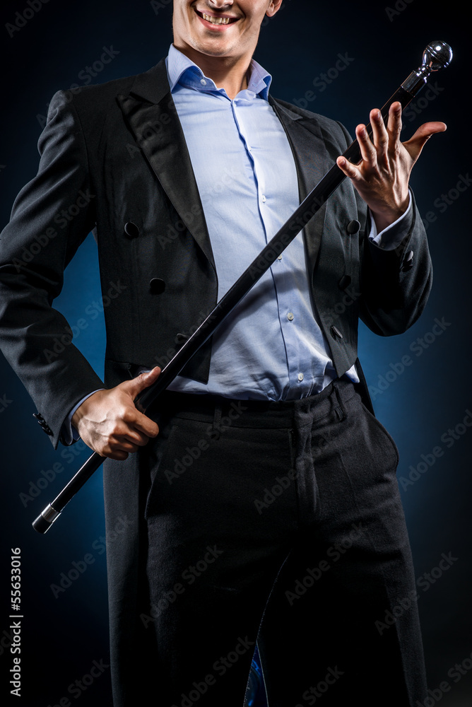 Elegant man holding cane with silver ball handle Elegant man holding cane with silver ball handle