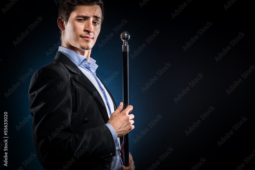 Elegant man holding cane with silver ball handle Elegant man holding cane with silver ball handle