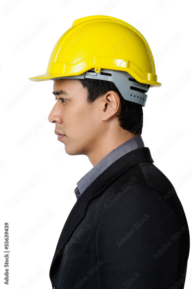 A solemn young foreman on the side view isolated A solemn young foreman on the side view isolated