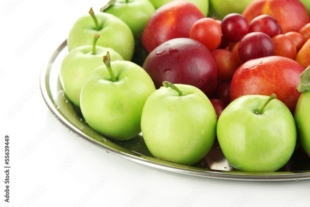 Assortment of juicy fruits on plate, isolated on white Assortment of juicy fruits on plate, isolated on white