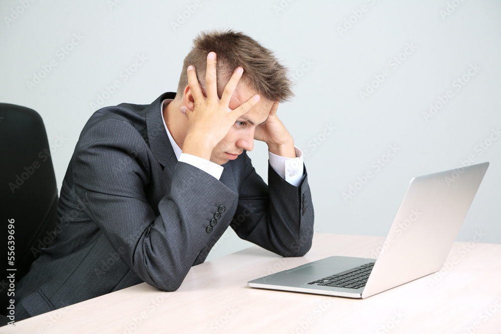 Portrait of young businessman working in office Portrait of young businessman working in office