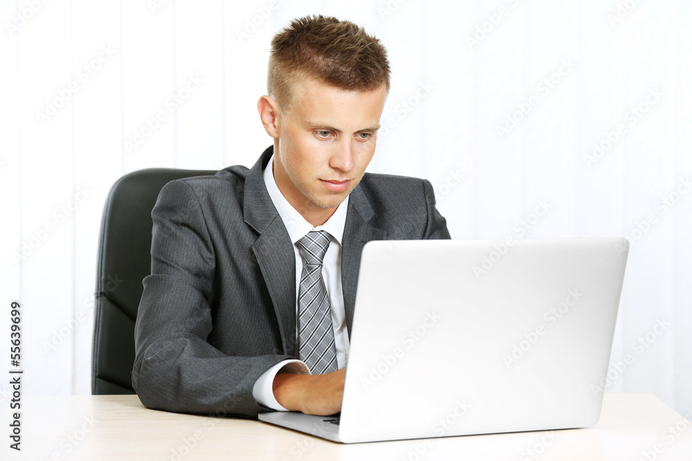 Portrait of young businessman working in office Portrait of young businessman working in office