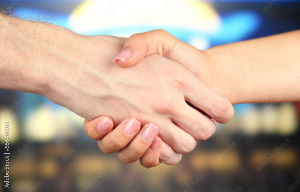 Handshake on bright background Handshake on bright background