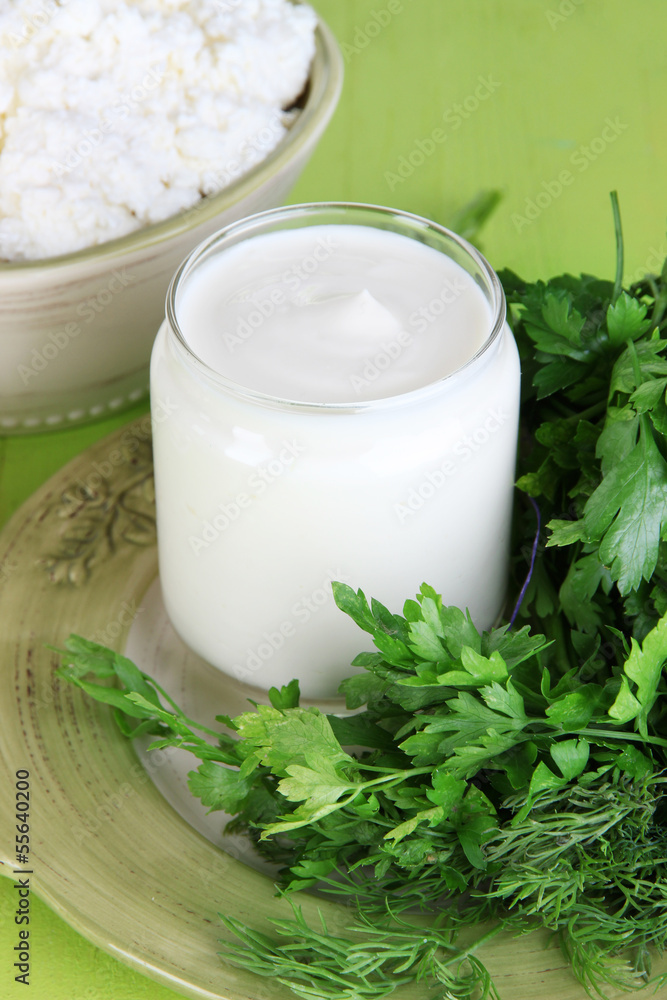 Fresh yogurt with greens on wooden table on natural background Fresh yogurt with greens on wooden table on natural background