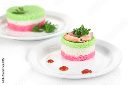 Colored rice on plates isolated on white