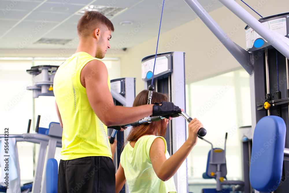 Girl and trainer in gym Girl and trainer in gym