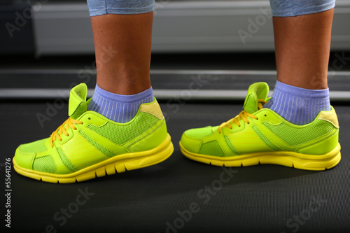 Women legs on treadmill in gum