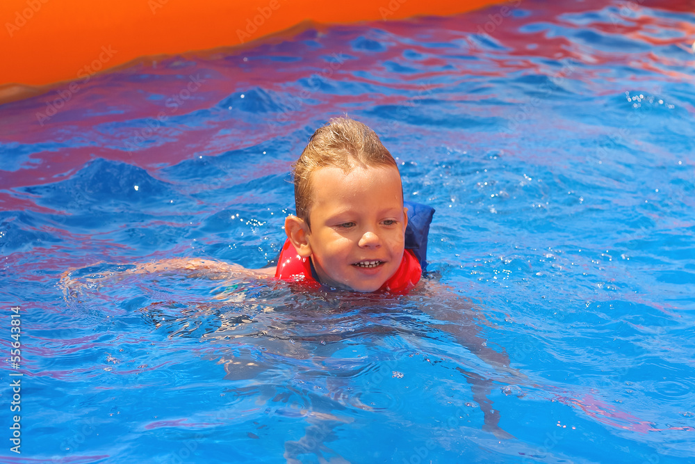 Enthusiastic kid in vest at the pool water park Enthusiastic kid in vest at the pool water park