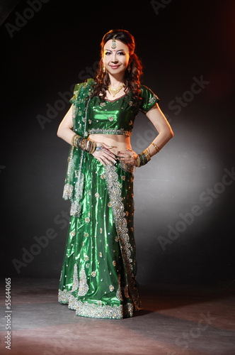 l female wearing traditional indian costume posing in studio