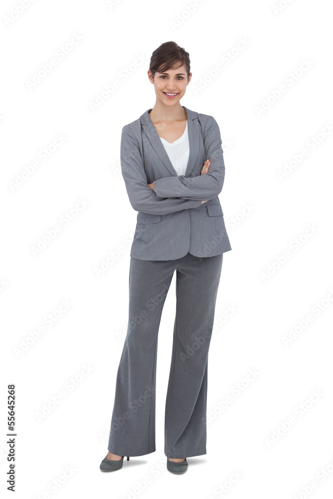 Young businesswoman with arms crossed smiling at camera Young businesswoman with arms crossed smiling at camera