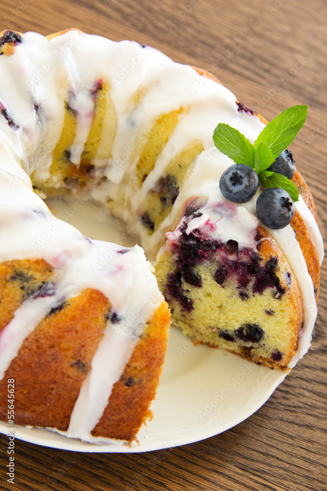 Kugelhopf cake with blueberries and lime, with a glaze.
