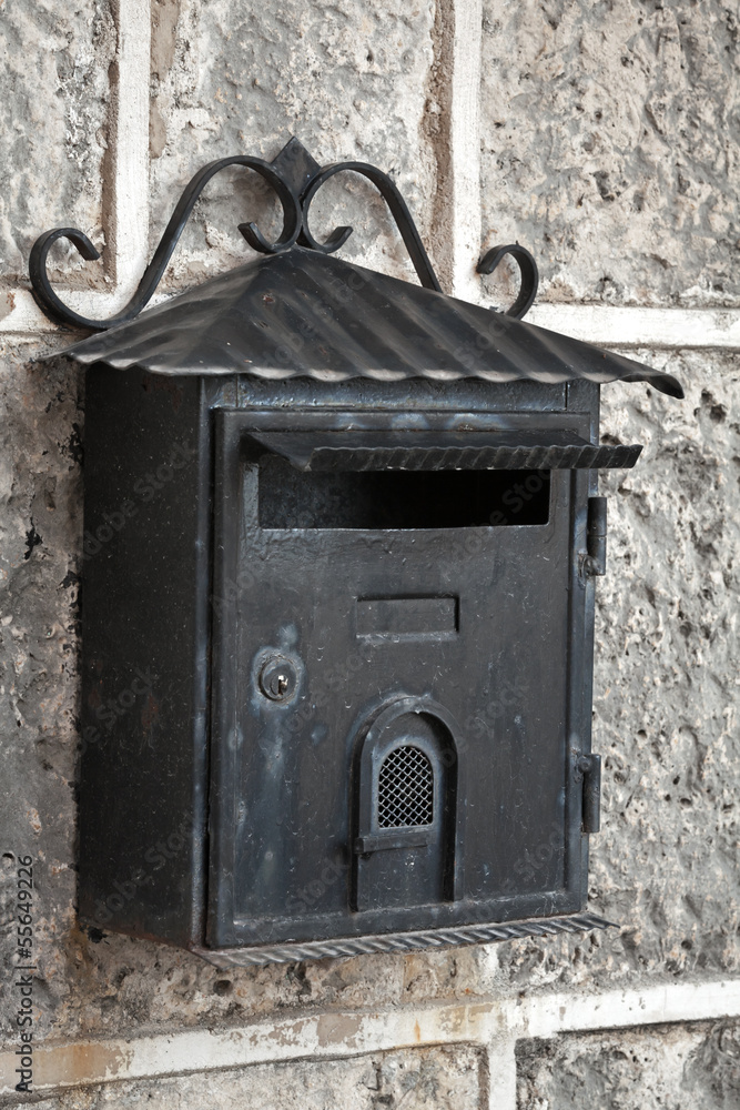 Old weathered black metal mailbox