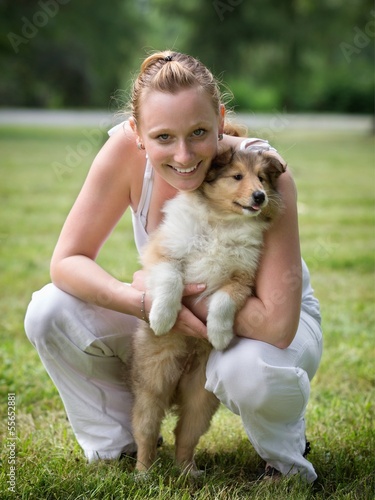 Young woman and puppy collie