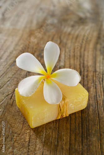 frangipani flower with soap on wood