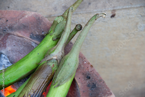 Green eggplant grilled on charcoal. photo