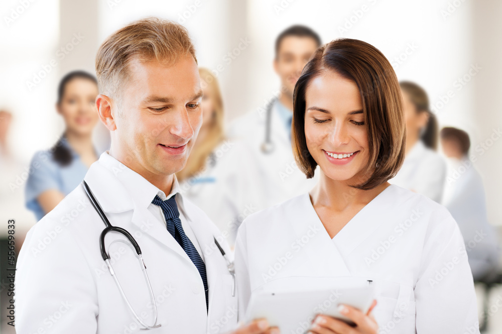 two doctors looking at tablet pc two doctors looking at tablet pc