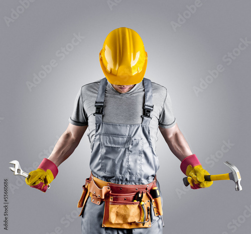 builder in a helmet with a hammer and a wrench © andy_di