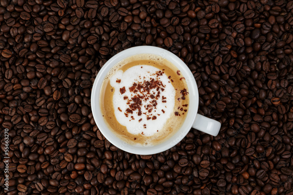cappucino in cup on coffee beans cappucino in cup on coffee beans