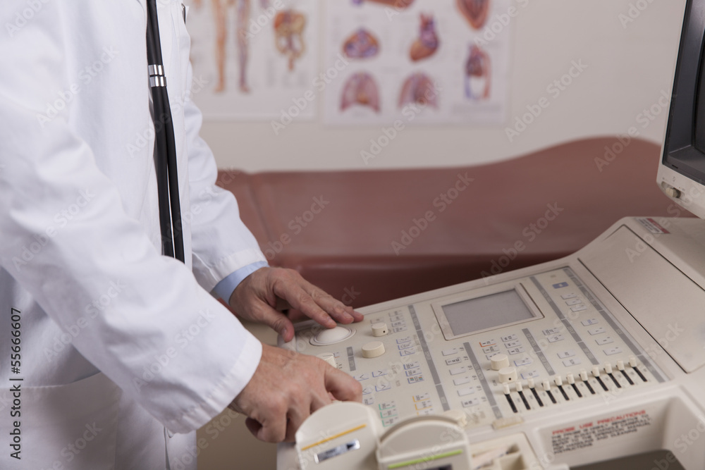 A medical professional uses an ultrasound machine in a doctors o A medical professional uses an ultrasound machine in a doctors o