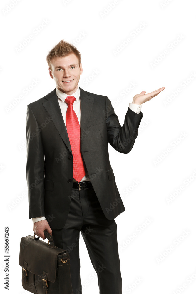 A young man pointing something isolated on white background A young man pointing something isolated on white background