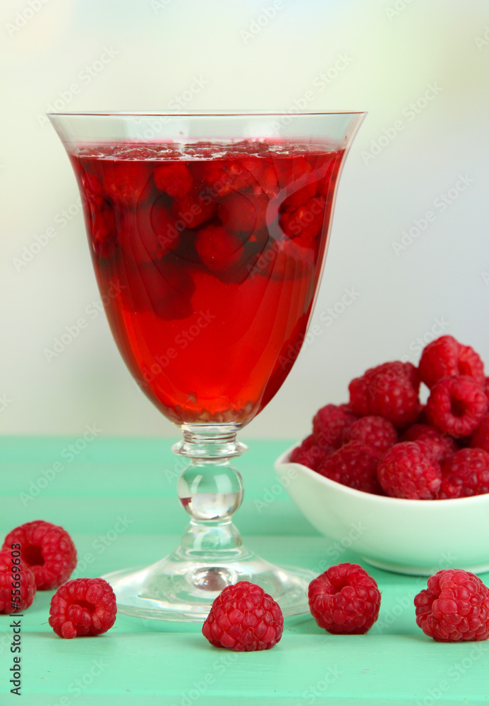 Jelly with fresh berries on green wooden table Jelly with fresh berries on green wooden table