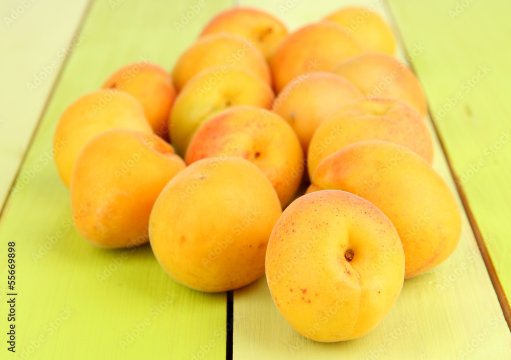 Fresh natural apricot on green wooden table Fresh natural apricot on green wooden table
