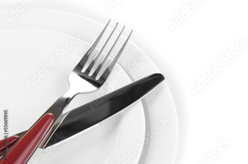 Knife, color plate and fork, isolated on white