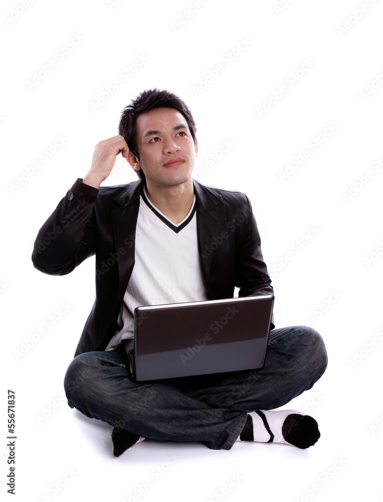 Portrait of young business man sitting using a laptop Portrait of young business man sitting using a laptop