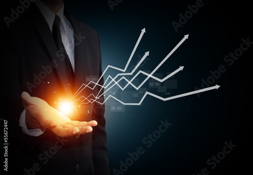Hand holding a rising arrow, representing business growth.