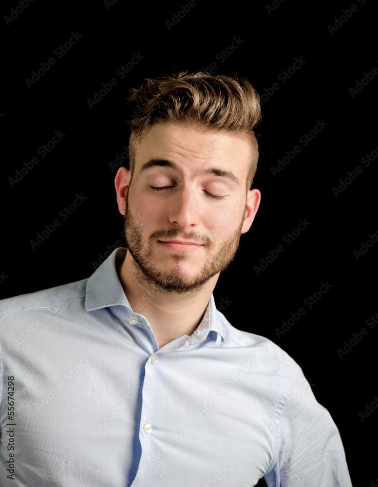 Handsome young man with confident expression, eyes closed Handsome young man with confident expression, eyes closed
