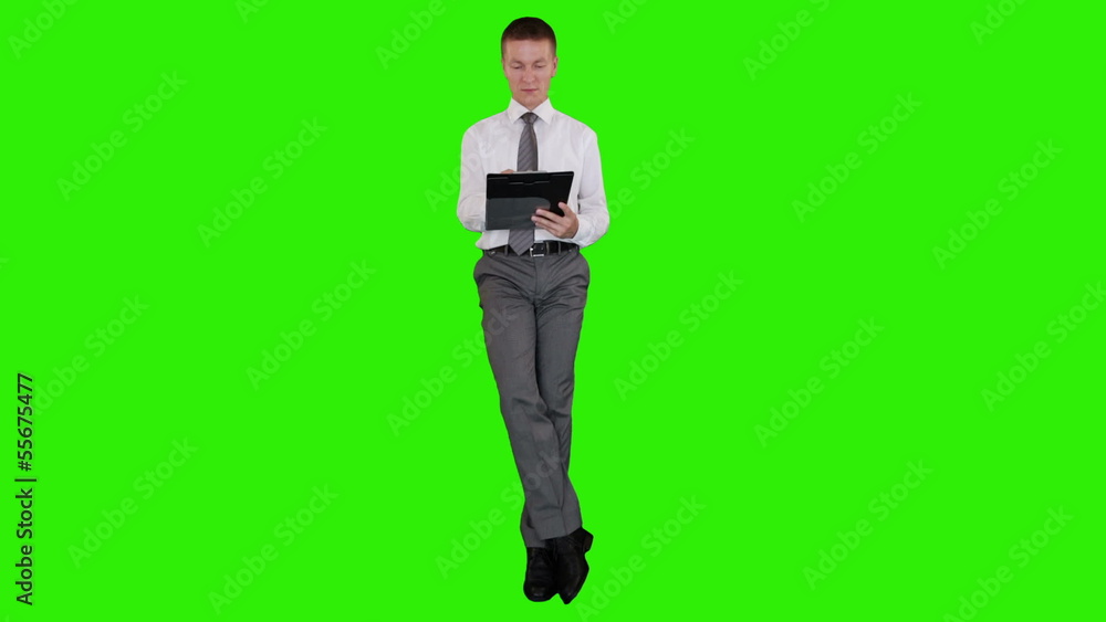 Young businessman writting on a clipboard, Green Screen Young businessman writting on a clipboard, Green Screen
